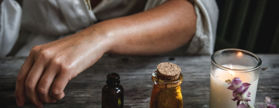 Woman putting essential oil on her wrist