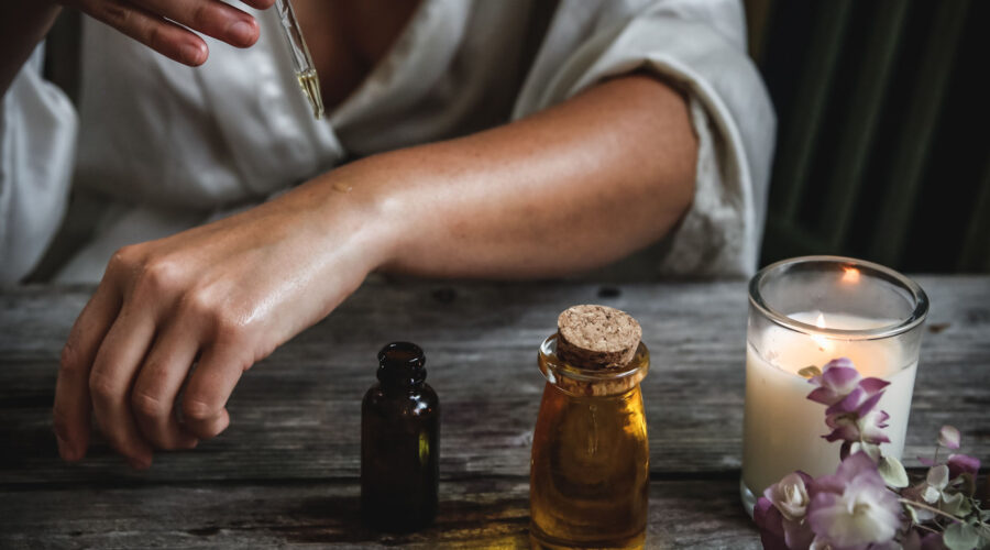 Woman putting essential oil on her wrist